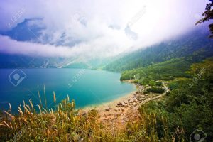 Fog over lake in mountains. Fantasy and colorfull nature landscape. Nature conceptual image. Morskie Oko in Tatry, Poland.